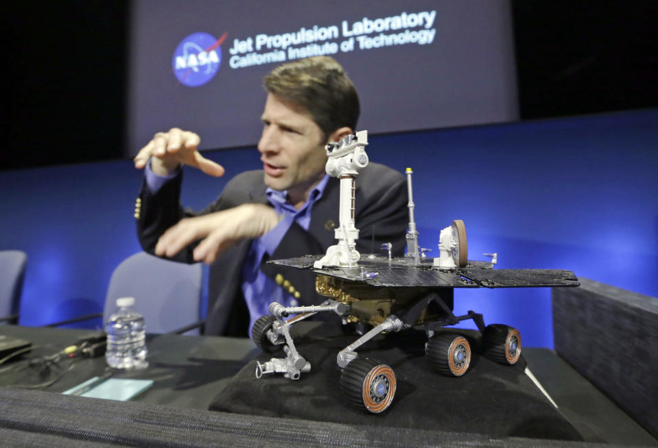 John Callas, Mars Exploration Rovers project manager, with a one-tenth Rover scale model, speaks at a news conference marking the 10th anniversary of the NASA Mars Opportunity rover mission, at a news conference at Jet Propulsion Laboratory in Pasadena, Calif., Thursday, Jan. 23, 2014. (AP Photo/Reed Saxon)