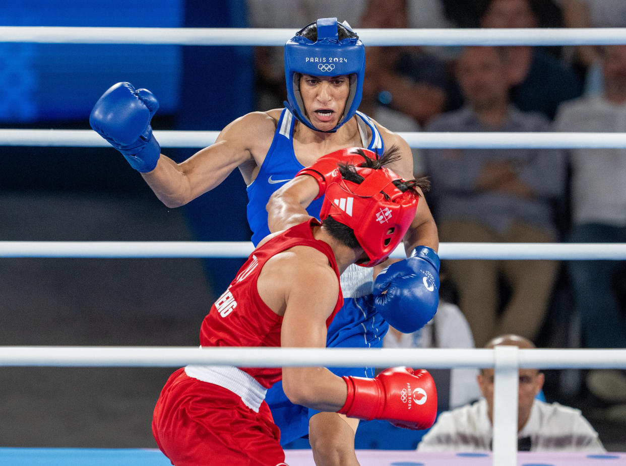 PARIS, FRANCE - AUGUST 6: Imane Khelif (blue) of Algeria competes against Janjaem Suwannapheng (red) of Thailand in the women's 66kg semi-final boxing match during the Paris 2024 Olympic Games at the Roland-Garros Stadium, in Paris, France on August 6, 2024. Khelif wins the match and advanced to final. (Photo by Aytac Unal/Anadolu via Getty Images)