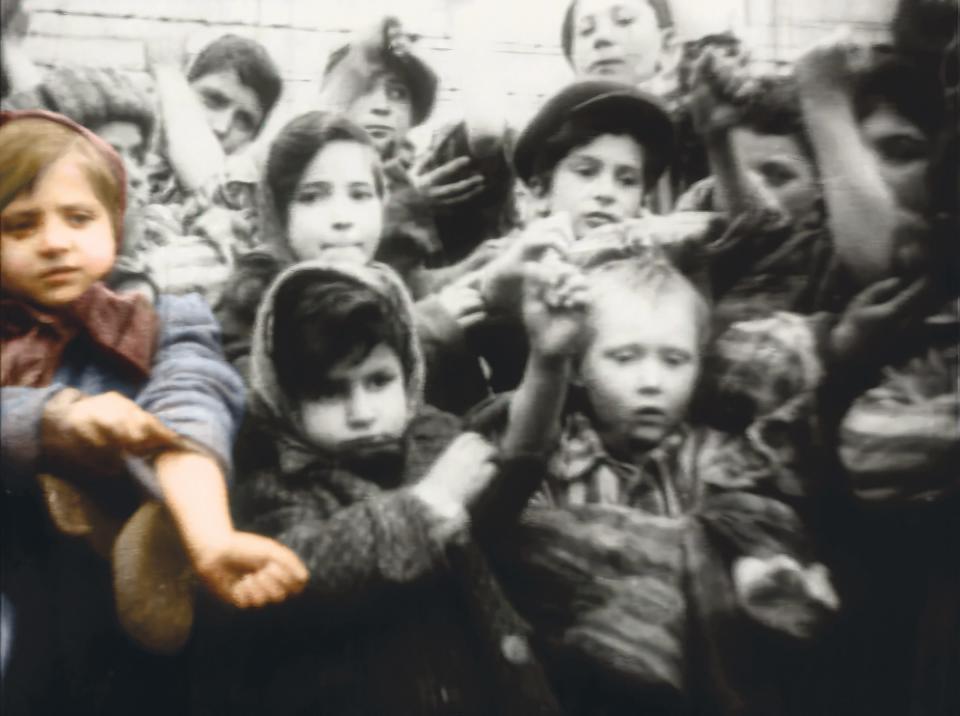 Tova and children during liberation by the allied forces. Tova is the child in color.