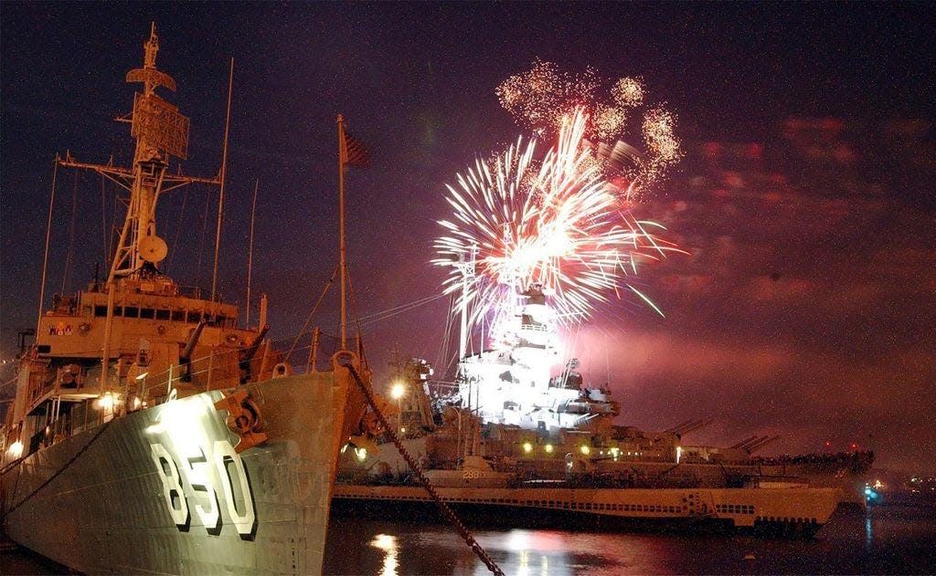 Fireworks light up the ships at Battleship Cove. [Herald News File Photo]