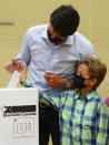 Liberal leader Justin Trudeau casts his ballot in the 44th general federal election as he's joined by his son Hadrien in Montreal on Monday, Sept. 20, 2021. (Sean Kilpatrick/The Canadian Press via AP)