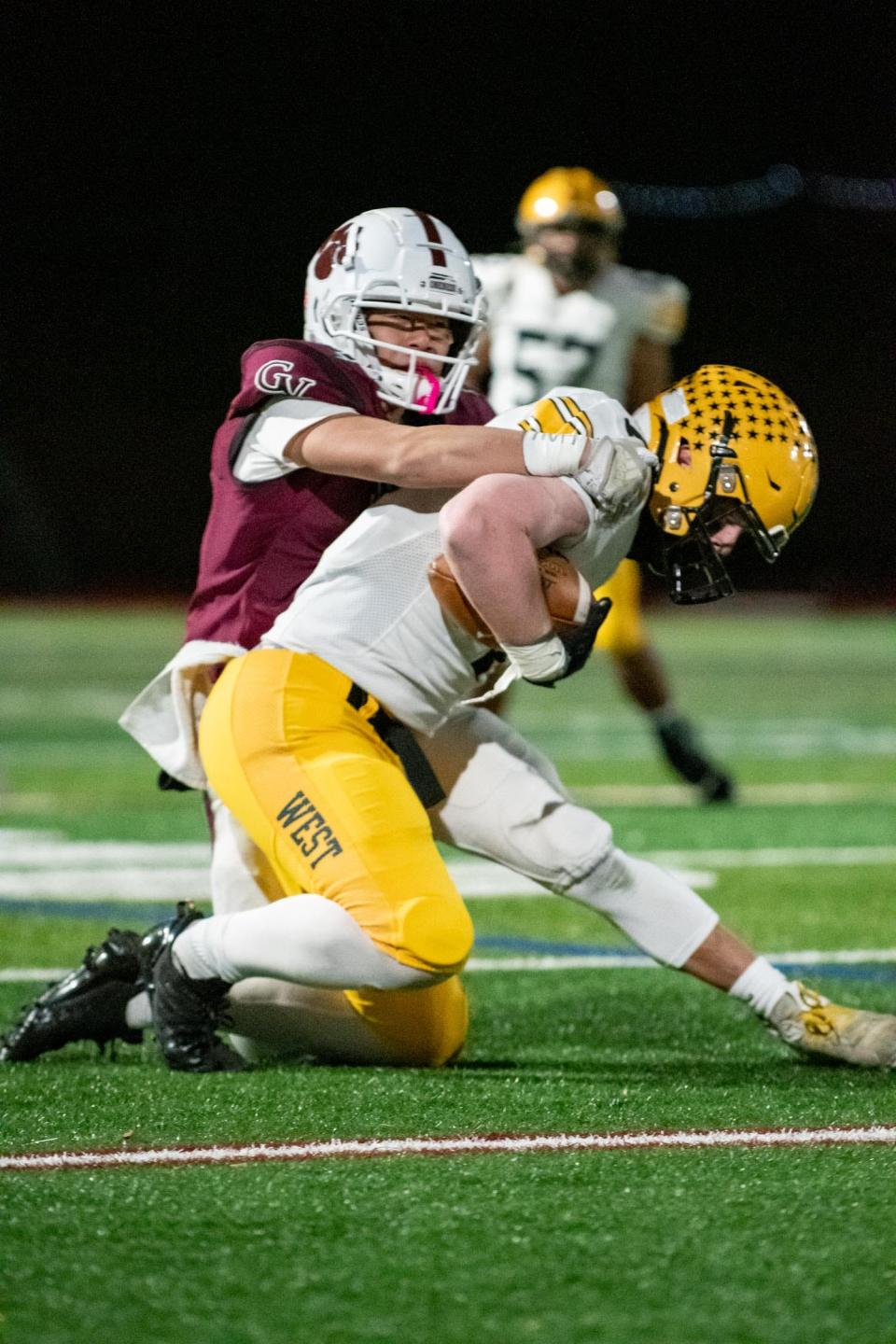 Central Bucks West tight end Jack Williams is tackled by Garnet Valley defensive back Kai Lopez in the PIAA District One Class 6A football championship game at Moe DeFrank Stadium in Collegeville on Friday, November 25, 2022. The Jaguars defeated the Bucks 35-7 for the district title.