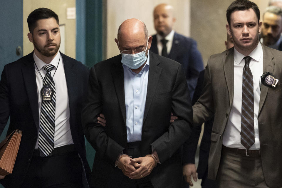 Allen Weisselberg, center, is escorted to Manhattan criminal court, Monday, March 4, 2024, in New York. Weisselberg, the former chief financial officer of the Trump Organization, surrendered to the Manhattan district attorney Monday morning for arraignment on new criminal charges, the prosecutor's office said. (AP Photo/Yuki Iwamura)