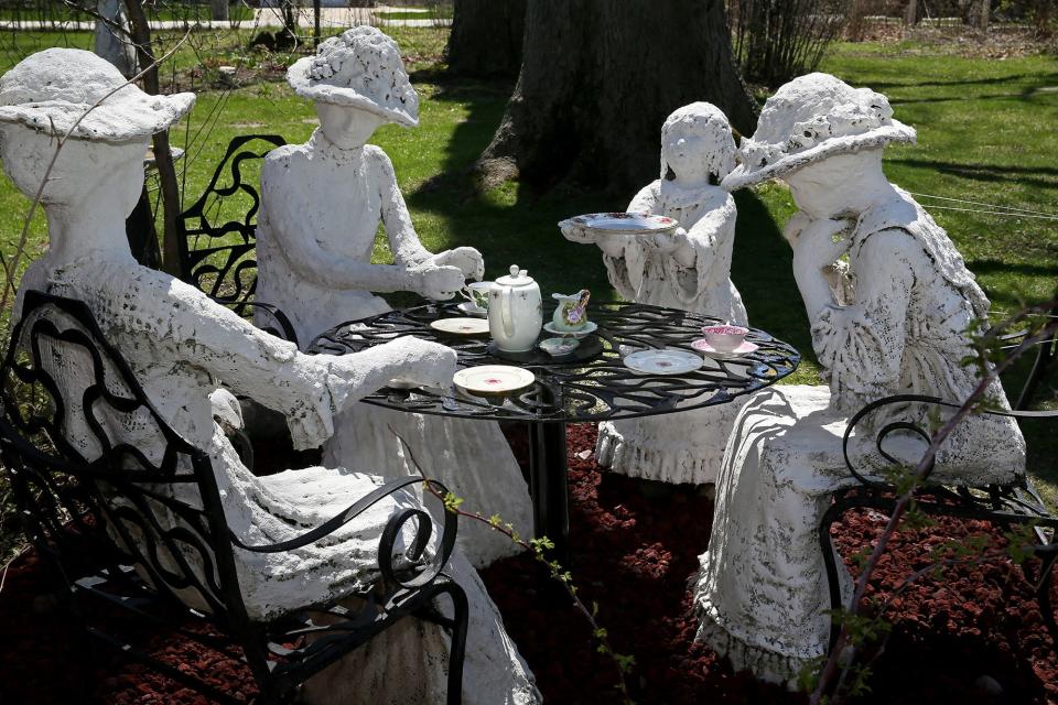 Tea party ladies, in statue form, sit outside the home of Kathleen Stanislawski and Frank Paul. The gardens will be on the Friends of the Muskego Library Garden Walk on June 25.