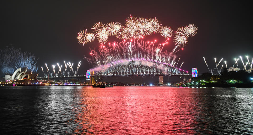The Sydney Harbour Bridge is bathed in fireworks and lighting effects during New Year's Eve celebrations on January 1, 2019 in Sydney, Australia.