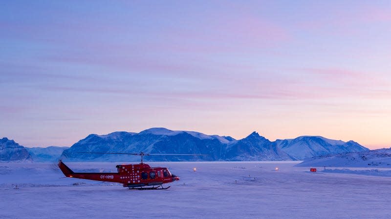 A photo of a helicopter on the Arctic ice sheet. 
