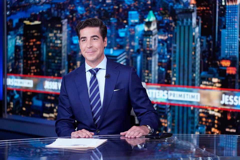 Jesse Watters is seen behind the anchor desk at his TV show.