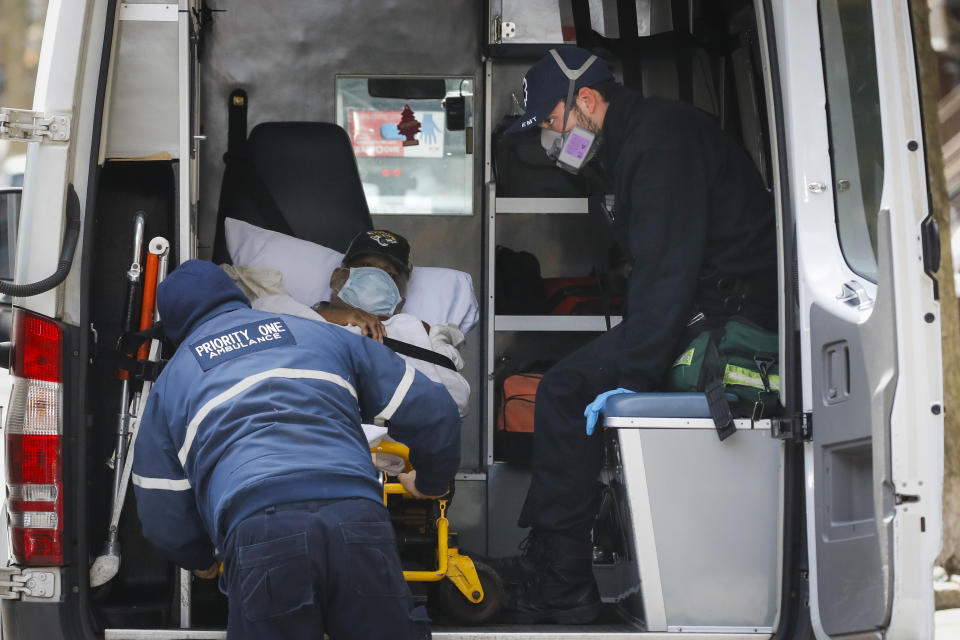 A patient is loaded into an ambulance outside Cobble Hill Health Center, Friday, April 17, 2020, in the Brooklyn borough of New York. The despair wrought on nursing homes by the coronavirus was laid bare Friday in a state survey identifying numerous New York facilities where multiple patients have died. (AP Photo/John Minchillo)