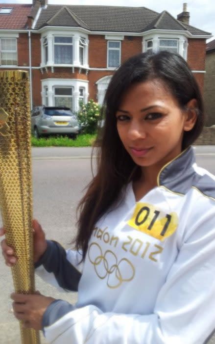 Begum carrying the Olympic torch in Newham, in 2012