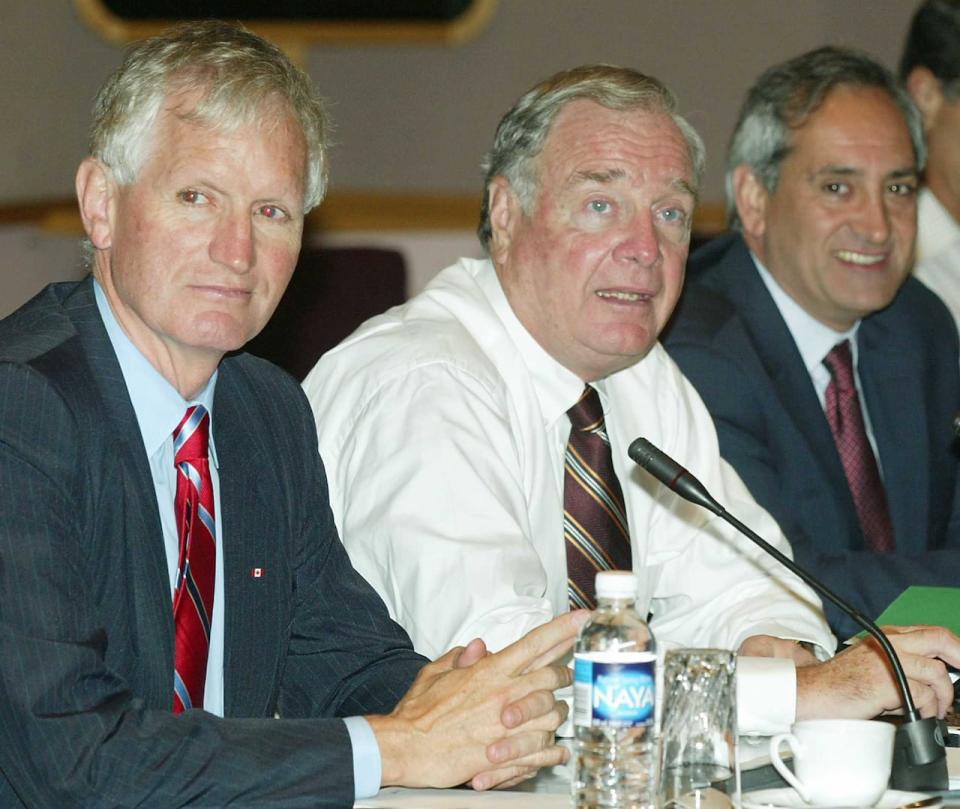 Prime Minister Paul Martin (centre) chairs a meeting with his cabinet flanked by Minister of State for Infrastructure and Communities John Godfrey (left) and Minister of State for Families and Caregivers Tony Ianno (right) in Ottawa, Thursday August 26, 2004.