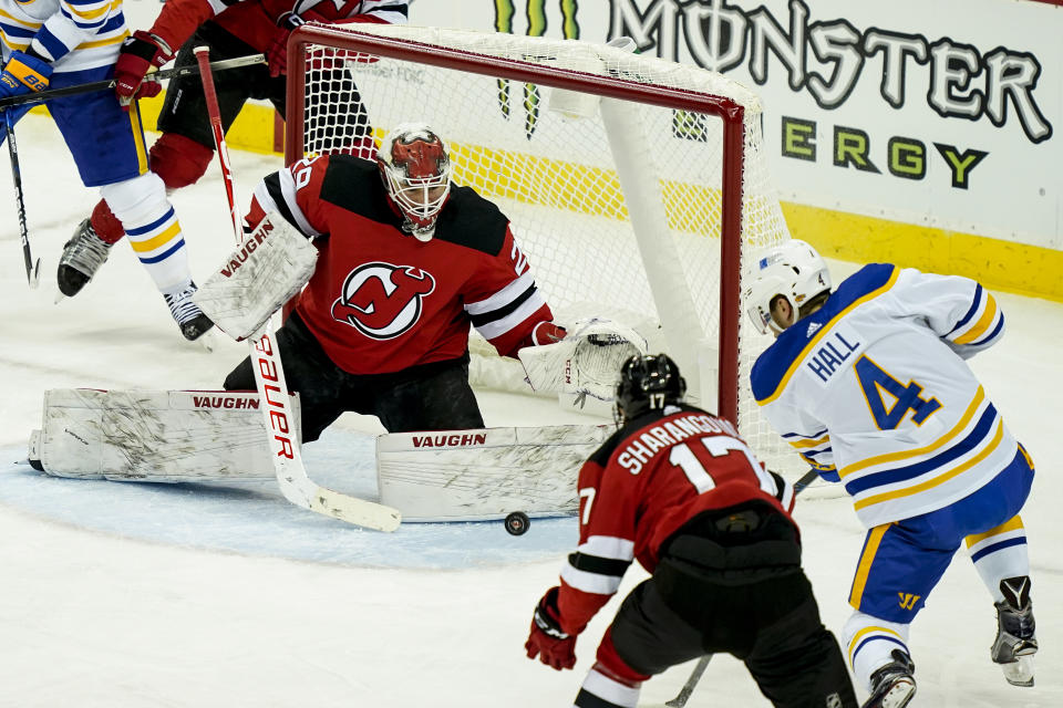 Buffalo Sabres left wing Taylor Hall (4) takes a shot on New Jersey Devils goaltender Mackenzie Blackwood (29) during the first period of an NHL hockey game, Saturday, Feb. 20, 2021, in Newark, N.J. (AP Photo/John Minchillo)