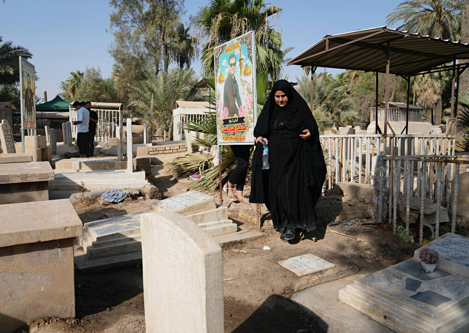 Iraqis visit the graves of their relatives during the first day of the Muslim feast of Eid al-Adha in Baghdad, Iraq, Saturday, July 9, 2022. Eid al-Adha marks the willingness of the Prophet Ibrahim (Abraham to Christians and Jews) to sacrifice his son. During the holiday, which in most places lasts four days, Muslims slaughter sheep or cattle, distribute part of the meat to the poor and eat the rest. (AP Photo/Hadi Mizban)