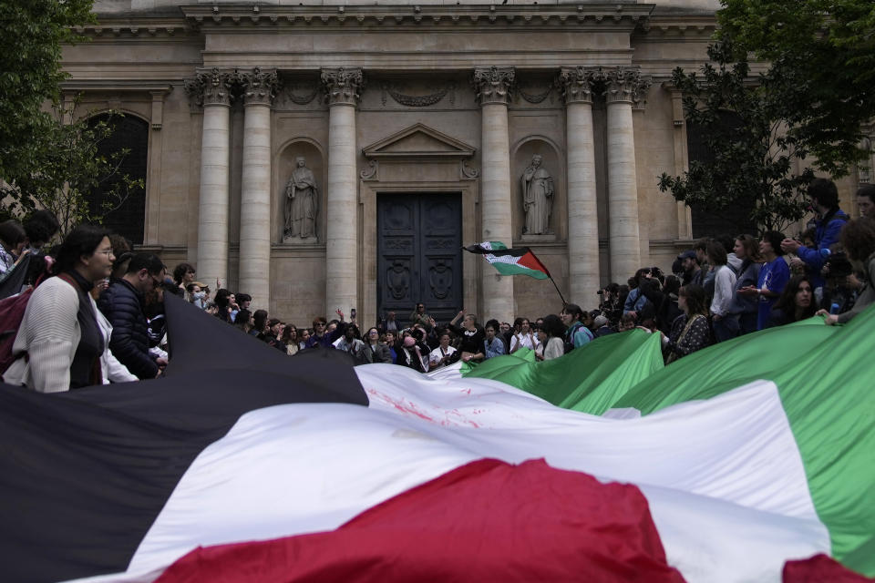 Students demonstrate outside La Sorbonne university with a huge Palestinian flag, Monday, April 29, 2024 in Paris. About 100 Pro-Palestinian students demonstrate near the Sorbonne university in Paris. The demonstration came on the heels of protests last week at another Paris-region school, Sciences Po. (AP Photo/Christophe Ena)