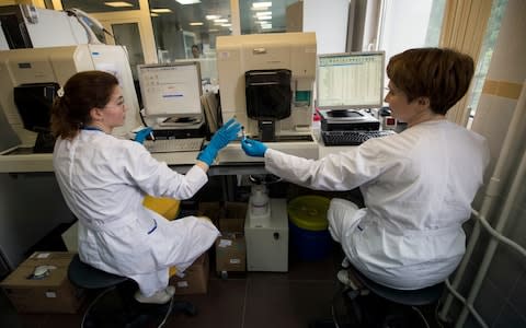 Employees at work in Russia's national drug-testing laboratory in Moscow - Credit: ap