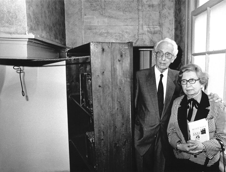 Miep and Jan Gies, years later, stand by the bookcase that hid a secret entrance to the hiding place of Anne Frank, her family and four others in Nazi-occupied Amsterdam (EPA)