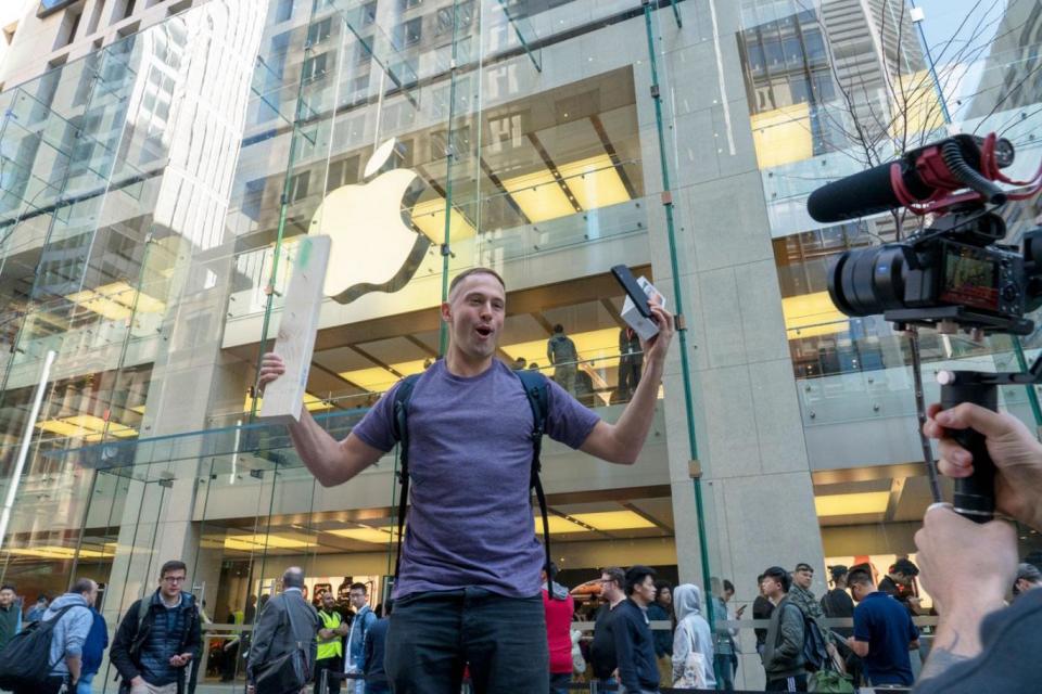 A customer carries out a 'drop test' on his new iPhone (Getty Images via Mous )