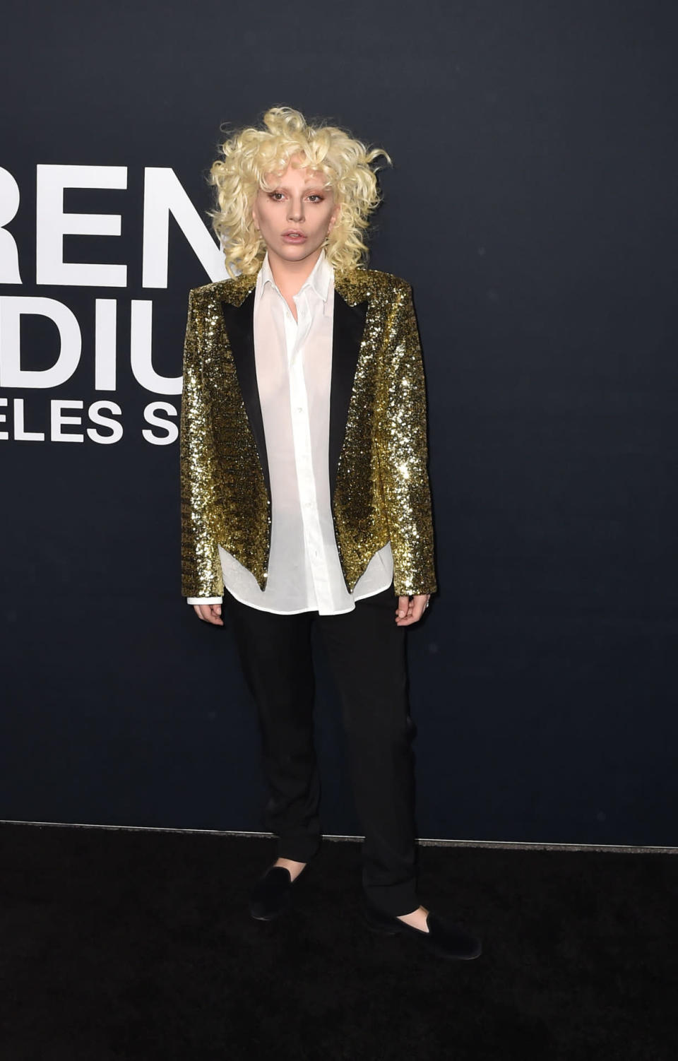 Lady Gaga in a gold Saint Laurent blazer with black jeans. 