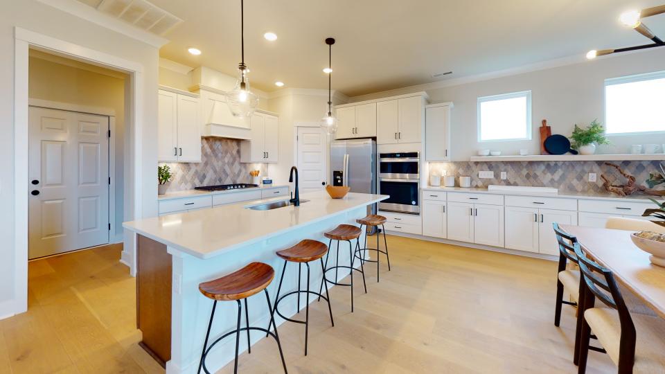 Pulte Homes’ new model home in Durham Farms features an eat-in kitchen with seating at the island. The Pulte Planning Center is located off the kitchen.