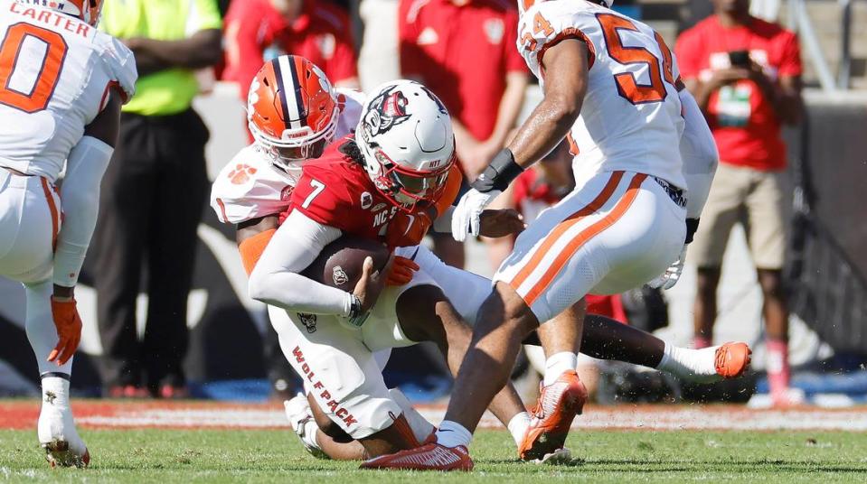 N.C. State quarterback MJ Morris (7) is sacked by Clemson’s Andrew Mukuba (1) during the first half of N.C. State’s game against Clemson at Carter-Finley Stadium in Raleigh, N.C., Saturday, Oct. 28, 2023.