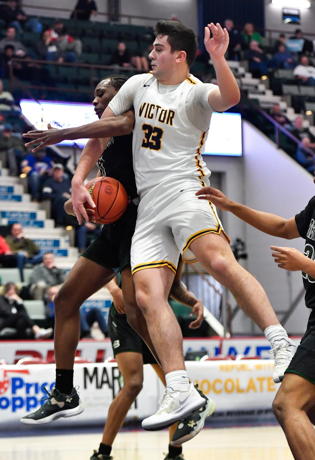 Victor's Nick Leonard, right, fights for a rebound against Brentwood's Frederic Diogene during a NYSPHSAA Class AA Boys Basketball Championship semifinal in Glens Falls, N.Y., Friday, March 17, 2023. Victor advanced to the Class AA title game with a 56-41 win over Brentwood-XI.