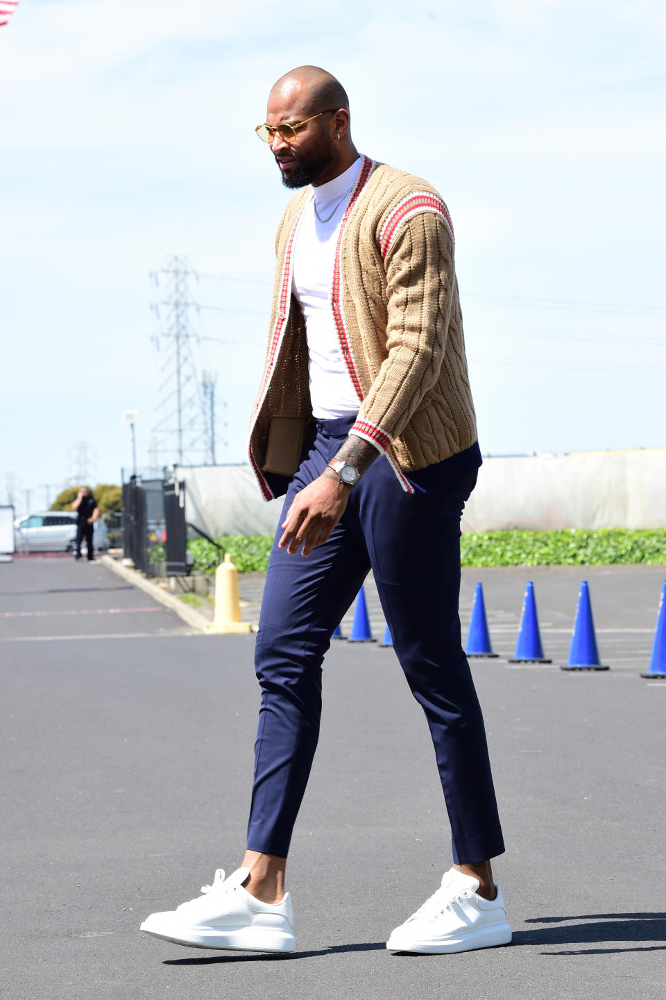 DeMarcus Cousins wears a light brown knitted cardigan Golden State Warriors arrives for the game against the LA Clippers during Game One of Round One of the 2019 NBA Playoffs on April 13.