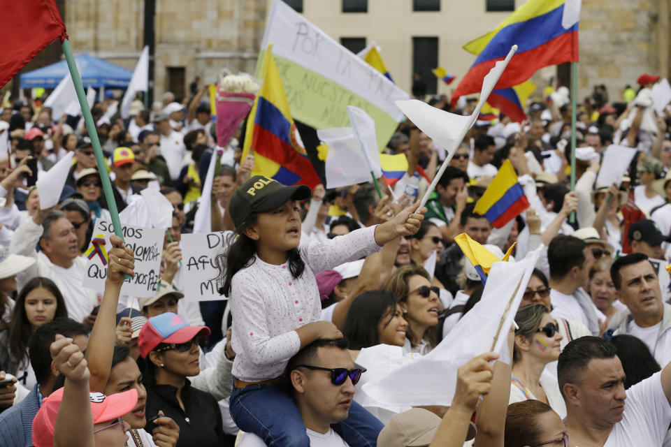 People rally to repudiate terrorism in Bogota, Colombia, Sunday, Jan. 20, 2019. A car bombing at a Bogota police academy that authorities have attributed to rebels of the National Liberation Army killed 21 people and left dozens more wounded on Jan. 17. (AP Photo/Fernando Vergara)