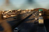 Several freight trucks drive down Highway 80 through Rodeo, CA