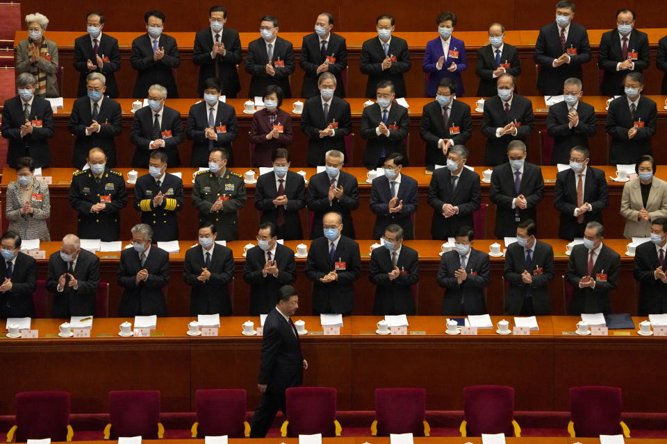 Delegates applaud as Chinese President Xi Jinping arrives for the opening session of China's National People's Congress (NPC) at the Great Hall of the People in Beijing, Friday, March 5, 2021. (AP Photo/Andy Wong)