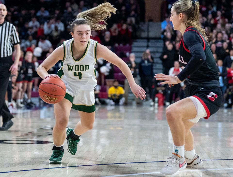 Archbishop Carroll's Brooke Wilson (5) tries to prevent Archbishop Wood's Ava Renninger (4) from getting to the basket during the Philadelphia Catholic League girls' basketball championship game Monday night at the Palestra.