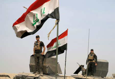 Iraqi special forces soldiers stand on top of armoured vehicles in a village near Mosul, Iraq October 25, 2016. REUTERS/Goran Tomasevic