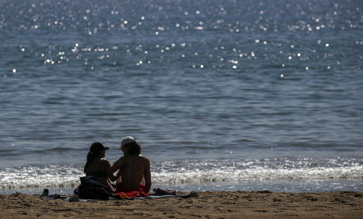 People on the beach in Bournemouth, Dorset. Picture date: Monday April 19, 2021.