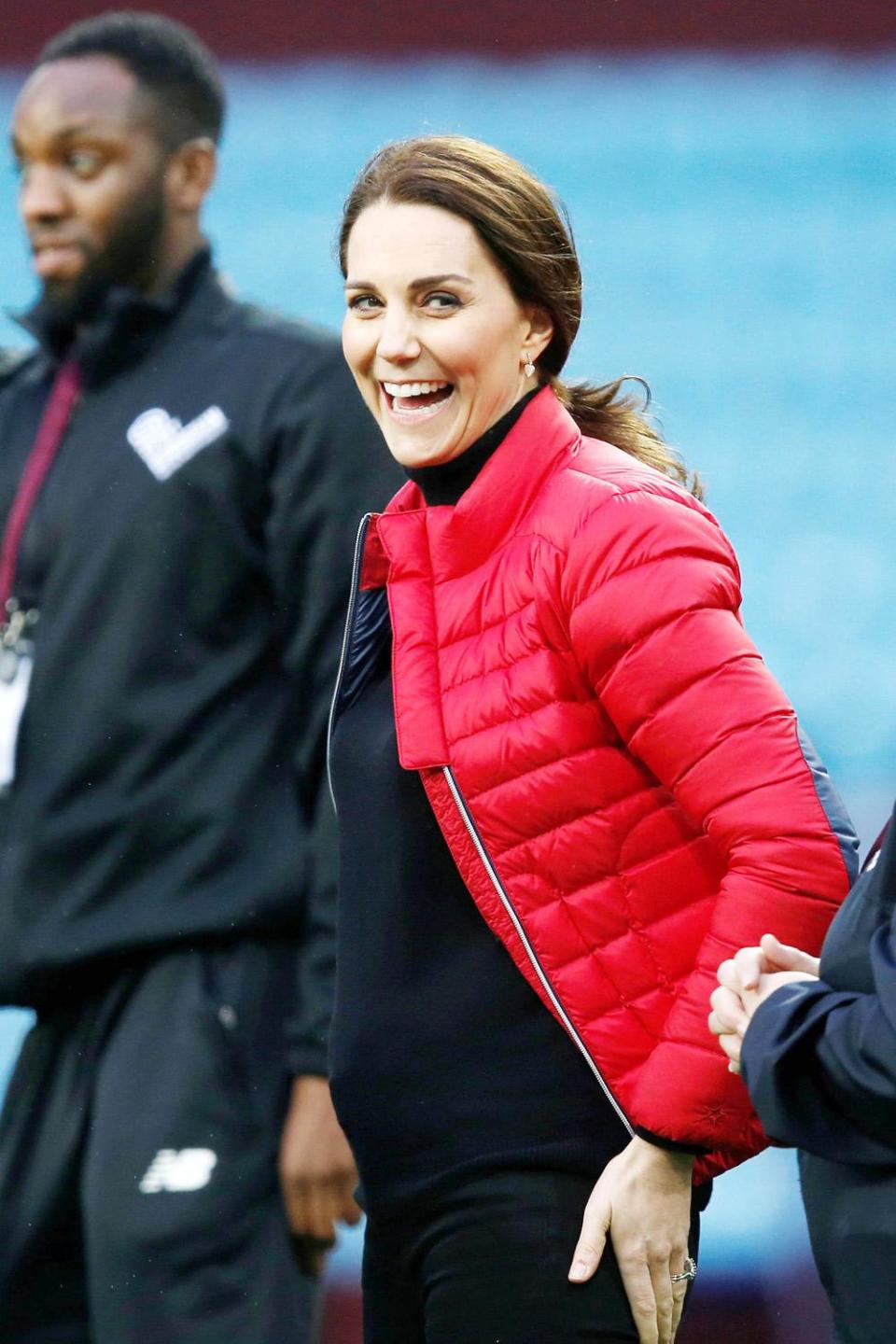 Bump: The Duchess looked happy and relaxed as she chatted to coaches (Andrew Yates/Reuters)