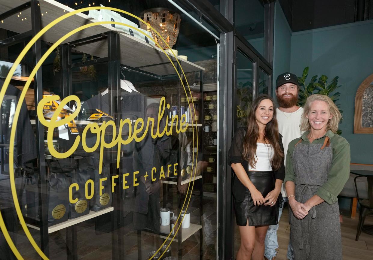 Copperline Coffee + Cafe owners Amelia and Nick West along with business partner/manager Dorothy Hopper, right, stand in front of their newest location at 118 S. Beach St. in downtown Daytona Beach, Wednesday, Oct. 25, 2023. It opened earlier this week. The Wests also own two Copperline locations in Port Orange.