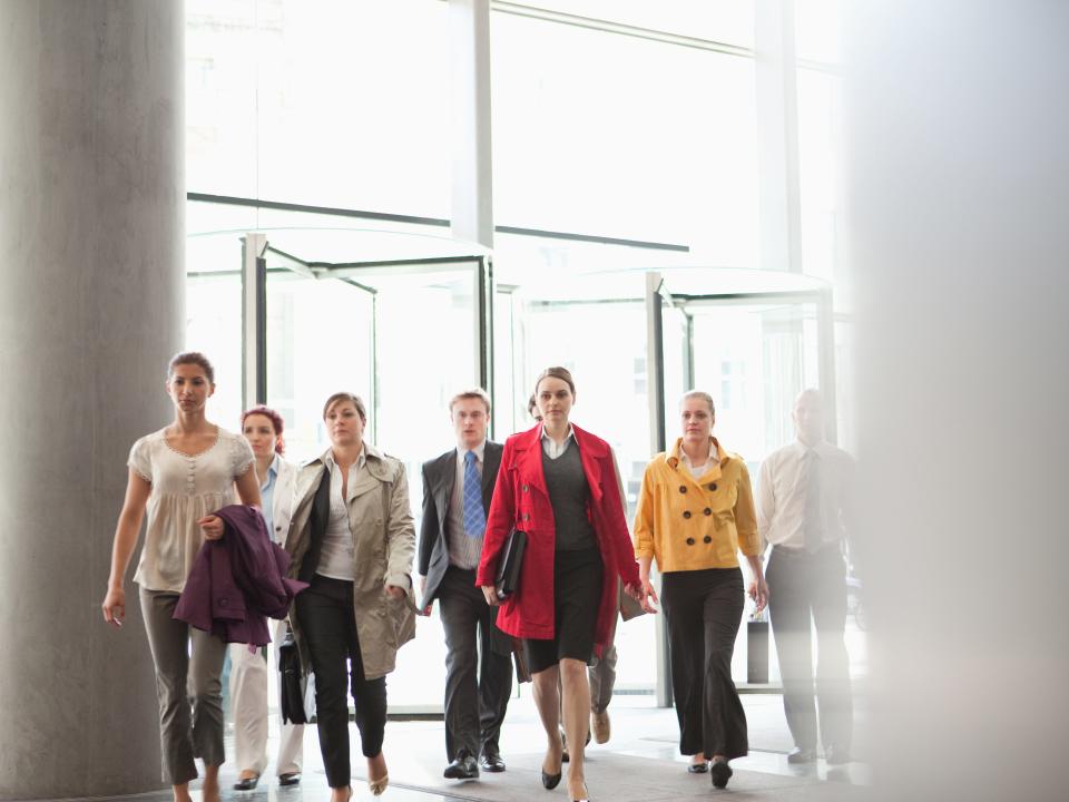 Business people walking in lobby.