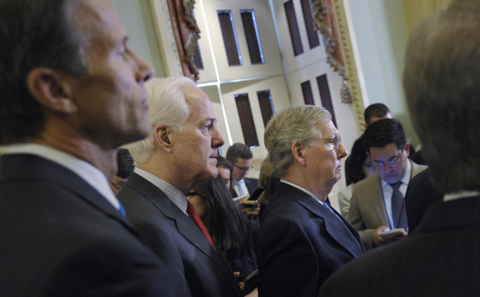 From left, Sen. John Thune, R-S.D., Senate Minority Whip John Cornyn of Texas and Senate Minority Leader Mitch McConnell of Ky., listen during a news conference on Capitol Hill in Washington, Tuesday, March 25, 2014, following a Republican policy luncheon with Senate Republicans. (AP Photo/Susan Walsh)