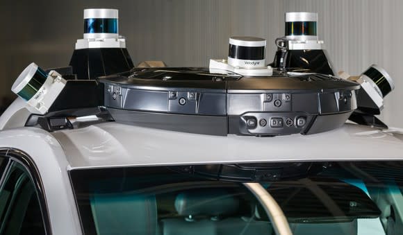 A close up of the Cruise AV's rooftop sensor array, showing several LIDAR sensors and an enclosed radar module.