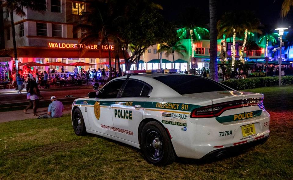 Miami-Dade Police Department is seen on Ocean Drive, on Saturday, March 26, 2022, hours before the midnight curfew imposed by the City of Miami Beach for the South Beach area, due to two shootings the weekend before that caused city officials to announce a “state of emergency”.