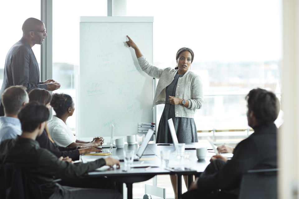 Business people in large modern meeting room