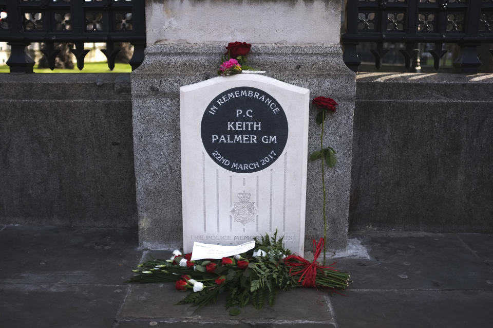 Pedestrians walk past the unveiled permanent memorial to PC Keith Palmer, the police officer killed in the March 22, 2017 Westminster terror attack, outside the Houses of Parliament in London on February 22, 2019. PC Keith Palmer was fatally stabbed as he stood guard in front of Britain's Houes of Parliament in Westminster on March 22, 2017 by Khalid Masood after the 52 year-old convert to Islam drove into pedestrians at high speed near parliament, killing four other people. (Photo by Alberto Pezzali/NurPhoto via Getty Images)