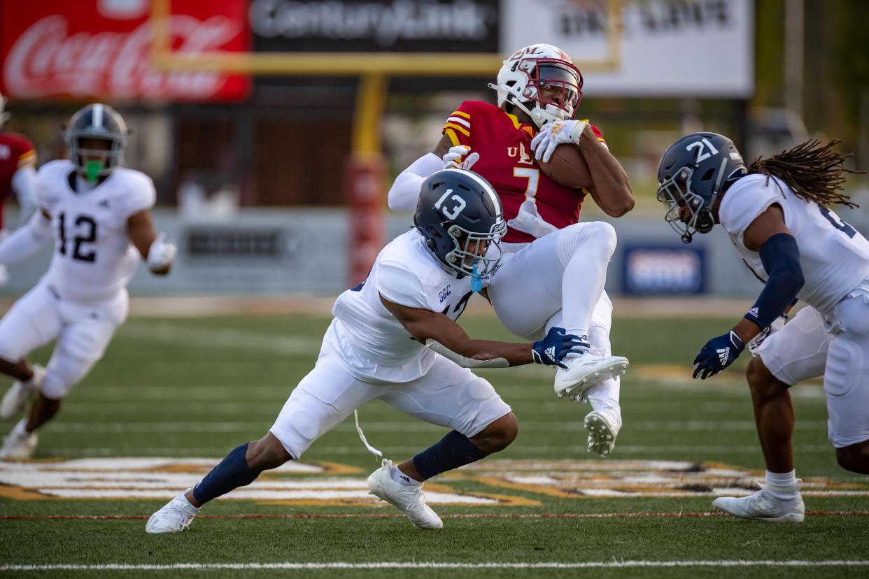 Georgia Southern cornerback Derrick Canteen (13) makes the tackle on ULM's Zach Jackson (7) as Eagles outside linebacker Zyon McGee (21) closes in during a game in 2020 in Monroe, Louisiana. Georgia Southern won 35-30.