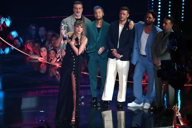 <p>TIMOTHY A. CLARY/AFP via Getty</p> Taylor Swift accepts the award for best pop video from *NSYNC at the 2023 MTV VMAs.