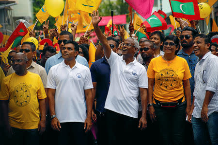 Ibrahim Mohamed Solih, Maldivian presidential candidate backed by the opposition coalition, waves as he stands next to his supporters during the final campaign rally ahead of the presidential election in Male, Maldives September 22, 2018. REUTERS/Ashwa Faheem