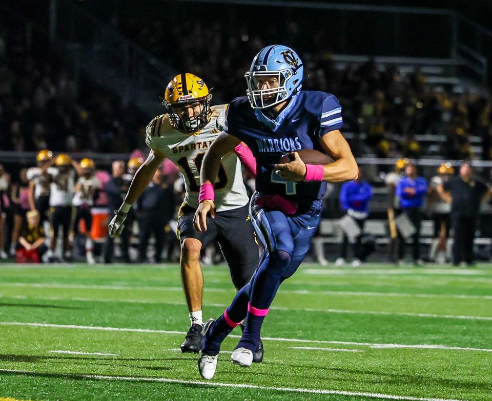 Central Valley quarterback Steven Rutherford (4) scrambles out of the pockets during the second half against Montour Friday night at Central Valley High School.