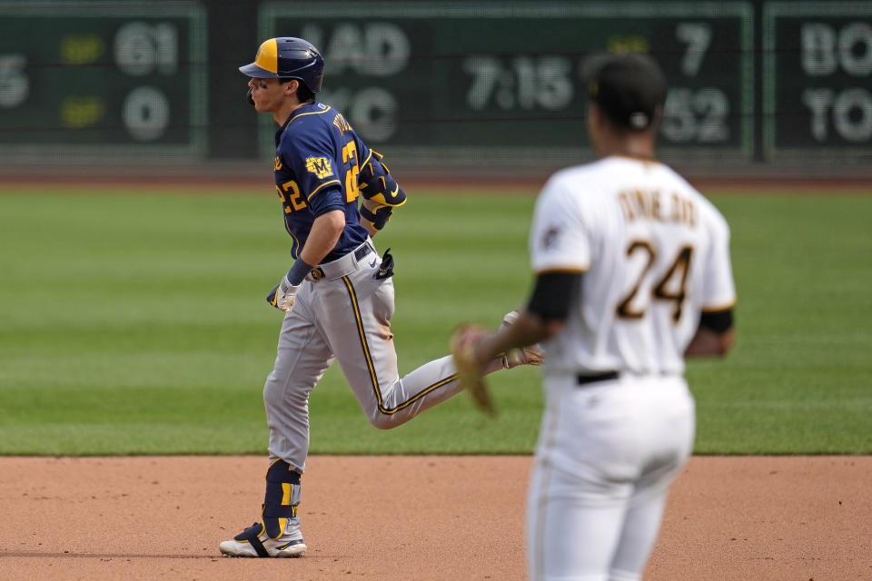 Milwaukee Brewers' Christian Yelich, left, rounds the bases after hitting a three-run home run off Pittsburgh Pirates starting pitcher Johan Oviedo (24) during the second inning of a baseball game in Pittsburgh, Saturday, July 1, 2023. (AP Photo/Gene J. Puskar)