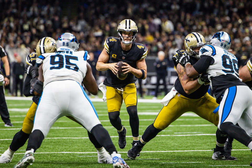 Dec 10, 2023; New Orleans, Louisiana, USA; New Orleans Saints quarterback Derek Carr (4) looks to pass against Carolina Panthers defensive tackle Derrick Brown (95) during the second half at the Caesars Superdome. Mandatory Credit: Stephen Lew-USA TODAY Sports