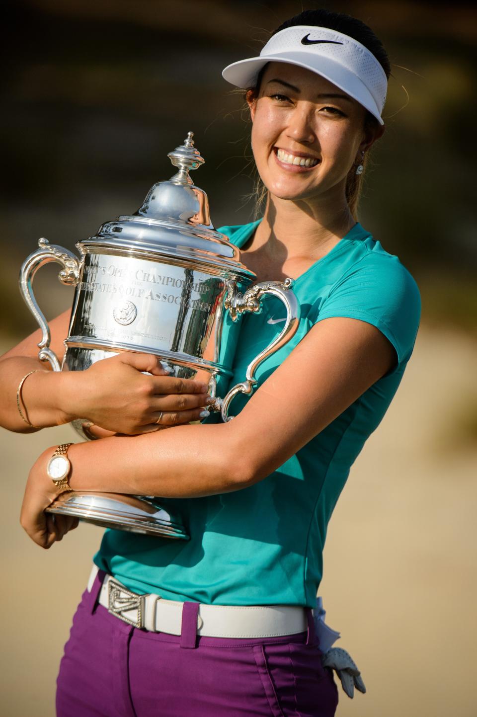 Michelle Wie holds the championship trophy after winning the U.S. Women's Open golf tournament, Sunday, June 22, 2014, in Pinehurst.