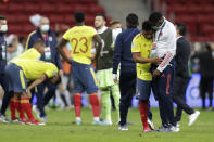 Colombia's Yimmi Chara, second right, is comfort by a member of the team after Argentina defeated Colombia in a penalty shootout during a Copa America semifinal soccer match at the National stadium in Brasilia, Brazil, Wednesday, July 7, 2021. (AP Photo/Eraldo Peres)