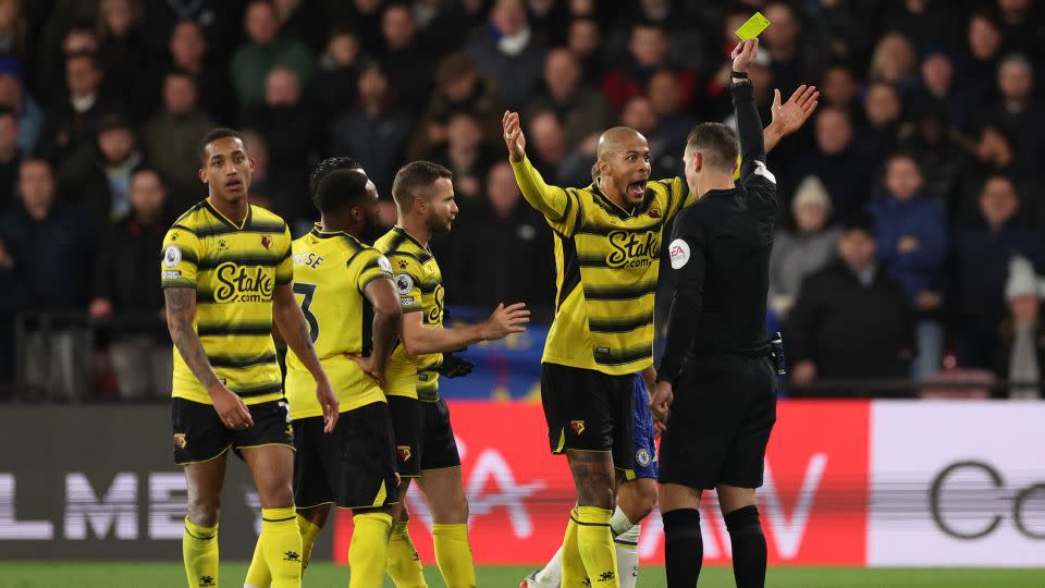 Watford's William Troost-Ekong is shown a yellow card during a Premier League match against Chelsea in December 2021. - Richard Heathcote/Getty Images