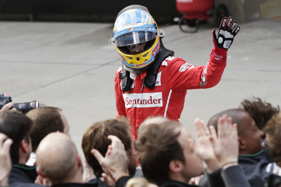 Ferrari driver Fernando Alonso of Spain celebrates after winning the third place after the Chinese Formula One Grand Prix at Shanghai International Circuit in Shanghai, Sunday, April 20, 2014. (AP Photo/Alexander F. Yuan)