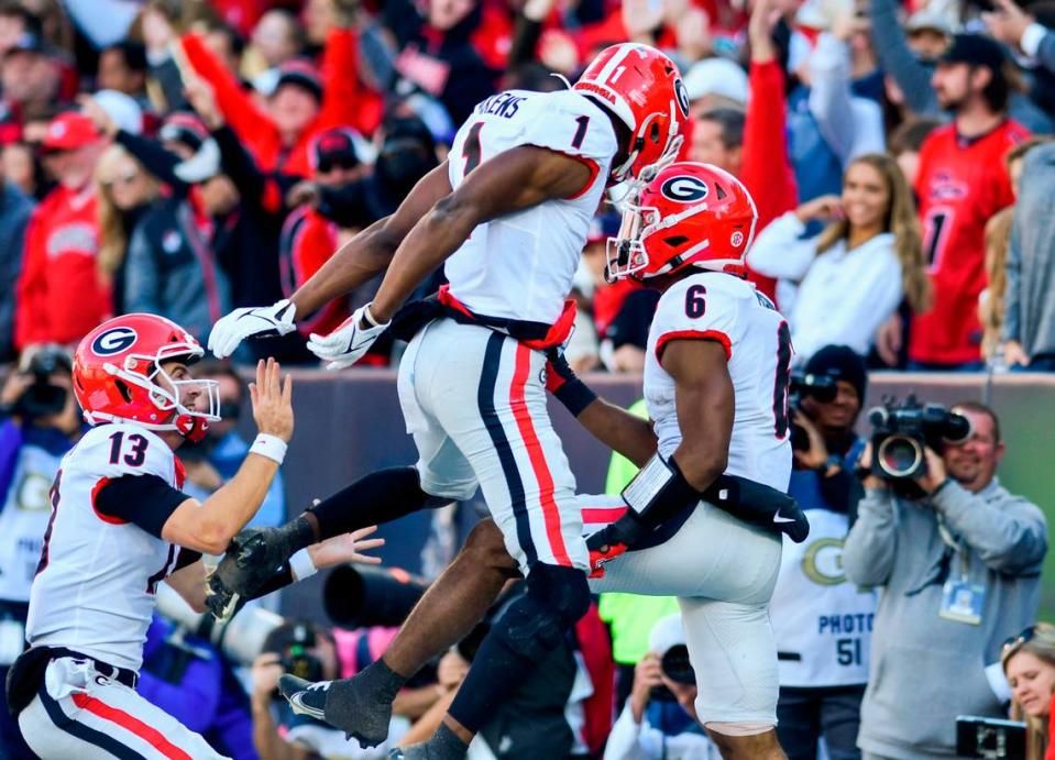 Georgia running back Kenny McIntosh (6) is congratulated by receiver George Pickens (1) and quarterback Stetson Bennett (13) after a touchdown during the Bulldogs 45-0 win over Georgia Tech Saturday in Atlanta.